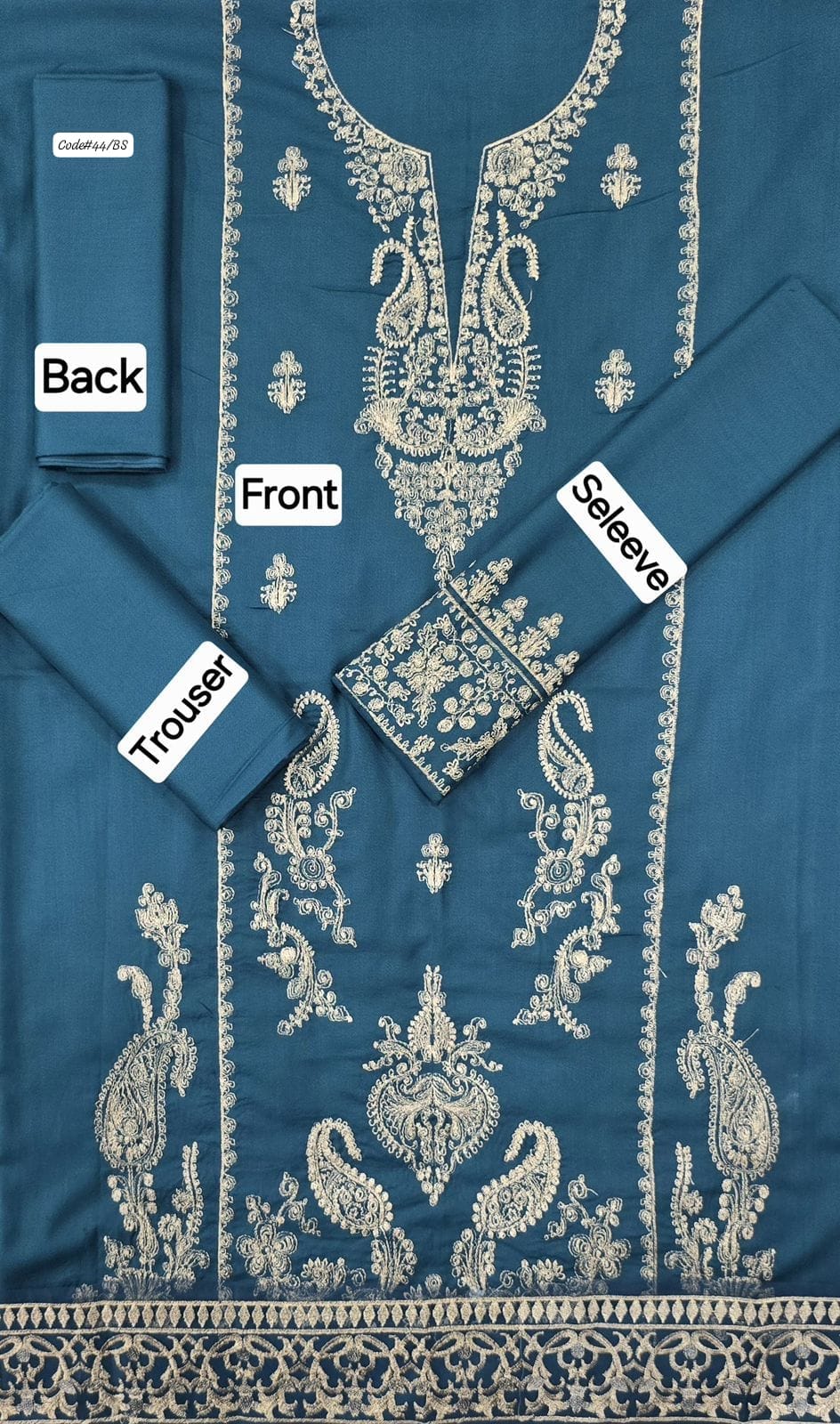 Blue embroidered outfit with labels indicating front, back, and sleeve views.